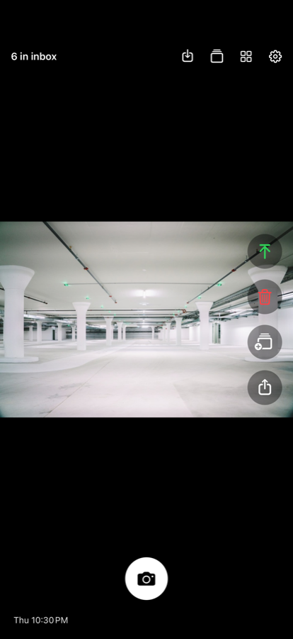 The triage feed showing one photo at a time with save, delete, album and share buttons